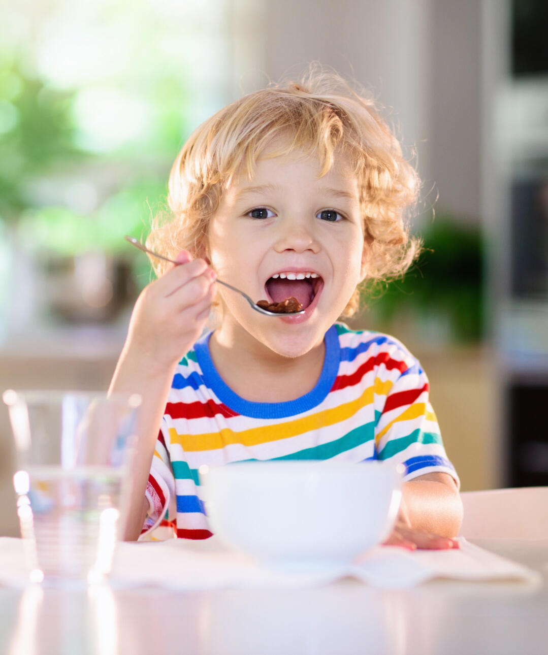 Young boy eating breakfast food