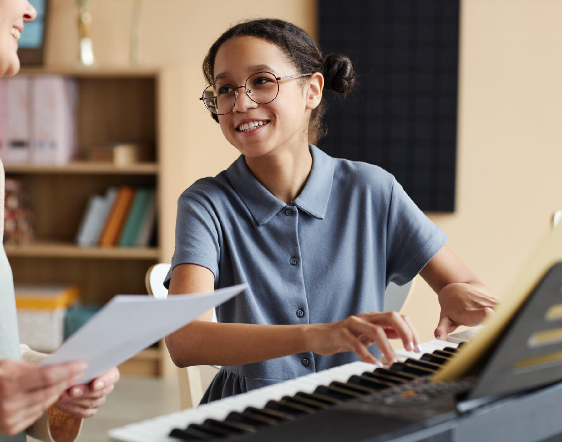 Girl learning to play the piano