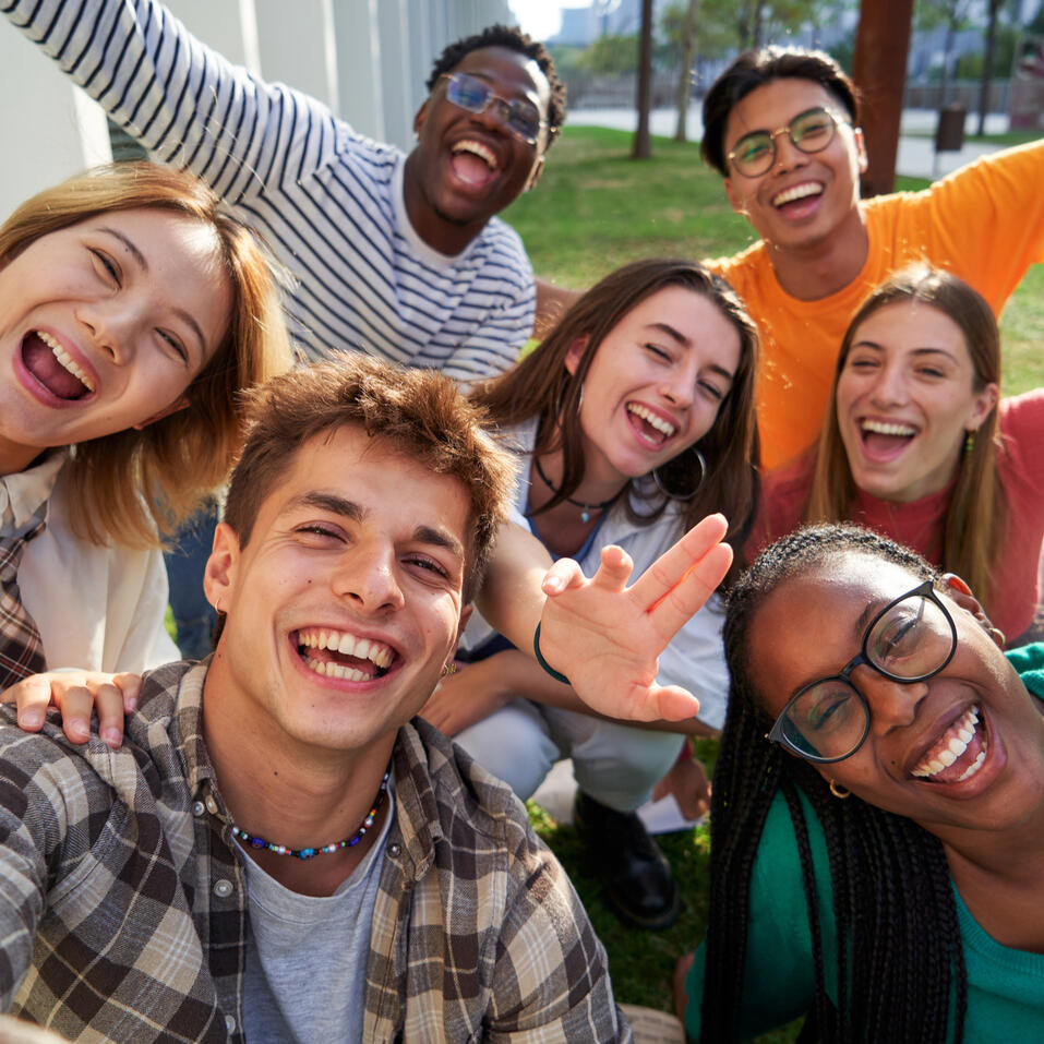 A group of older teens laughing and smiling